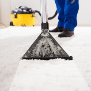Close-up,Of,A,Janitor,Cleaning,Carpet,With,Vacuum,Cleaner,At
